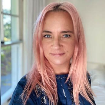 smiling woman with pink hair